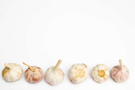 Garlic isolated on plain white background. Close-Up View of Raw Garlic Segments on White Background. Copy space.の写真素材