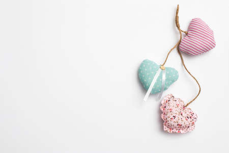 Copy space. Greeting card for Valentine's Day. Multi-colored hearts sewn from fabric with buttons.