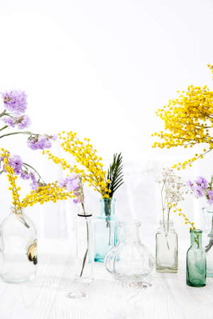 A small variety of pharmacy bottles instead of a vase for dried flowers.の写真素材