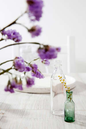 A small variety of pharmacy bottles instead of a vase for dried flowers.の写真素材