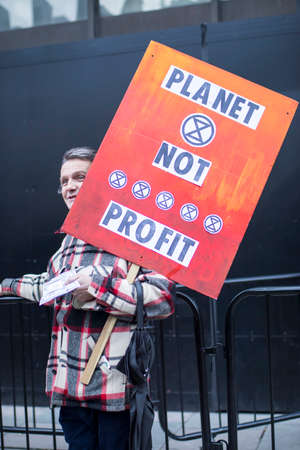 LONDON, UK- febryary 15 2020: A man with a banner "Planets not profit" protests against fast fashionのeditorial素材