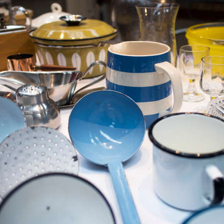 London, UK - 13 February, 2020 Spitalfields flea market. Enameled ladles, colander, knives and other kitchen utensilsのeditorial素材