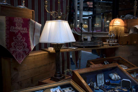 London, UK - 13 February, 2020 Spitalfields flea market. White table lamp and jewelry in drawersのeditorial素材