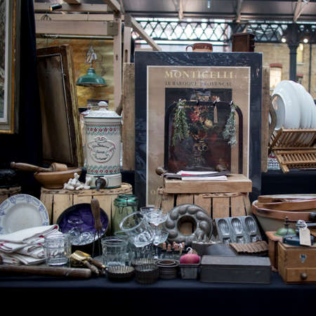 London, UK - 13 February, 2020 Spitalfields flea market. Posters, framed antique paintings, kitchen utensils for saleのeditorial素材