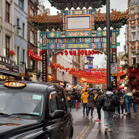 LONDON, UK - March 20, 2020: Chinatown with unidentified people on a rainy day. Chinatown is part of the Soho area with a range of Chinese restaurants and other Chinese run businesses.のeditorial素材