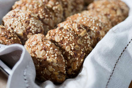 Oatmeal cookies, sprinkled with sesame seeds and almonds are in a beige napkin in a baking dish after cooking. Cookingの写真素材