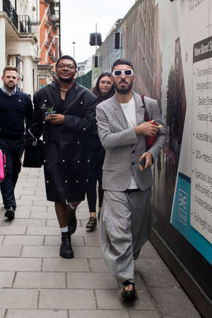 London, UK - 15 January, 2020, Fashionable people on the street. Street style. Short-haired man with...