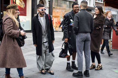 London, UK - 15 January, 2020, Fashionable people on the street. Street style. Short-haired man with...