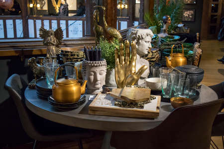 London, UK - 23 February 2020, The interior of the Liberty store on Regent Street. A large table with a white tablecloth is served with china, with flowers in large vases.のeditorial素材