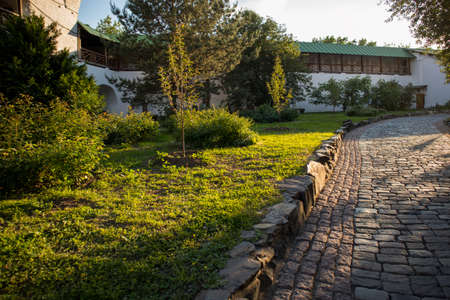 The walls of the ancient Russian Novospassky monastery and a beautiful garden at sunset. Nature