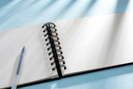 An open notebook on springs with white craft paper lies on a table. Concept for business ideas. Home...