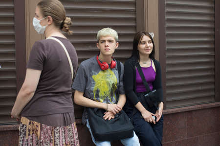 Moscow, Russia - 06 July 2020, A young couple leaned against the building. Young blond man in a gray t-shirtのeditorial素材