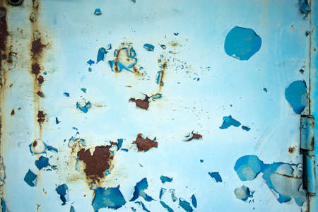 Texture of a metal wall with cracks and scratches which can be used as a background. Blue with rust....