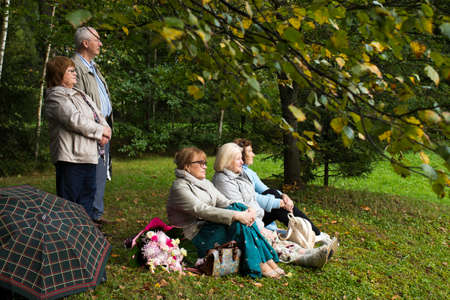 Moscow, UK - 10 September 2020, Seniors sit on the grass listening to a concert in the parkのeditorial素材