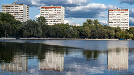 Moscow, Russia - 14 September 2020, Multi-storey nine-storey buildings are reflected in Golovinsky ponds in good weatherのeditorial素材
