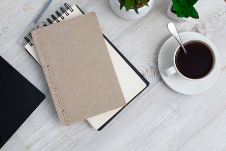 Office desk wood table of Business work place, notebook, artificial plant and coffee cup with copy...