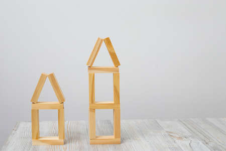 A house built of blocks on a wooden table. Concept of housingの写真素材