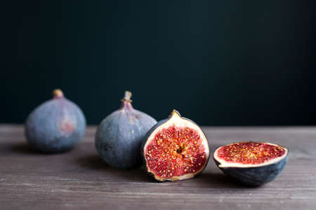 Bunch of fresh ripe figs on wodden brown background. Tropical fruitの写真素材