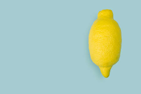 Creative layout made of lemon on blue background. Flat lay. Food concept. images. Copy space. Space for textの写真素材