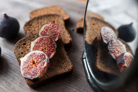 Bunch of fresh ripe figs on wodden brown background. Tropical fruit