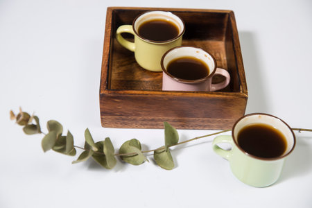 Mango wood wooden tray with four espresso coffee cups on the white background. Empty spaceの写真素材