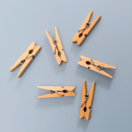 Clothespins are on a blue background as a decoration or a design card. Square frame
