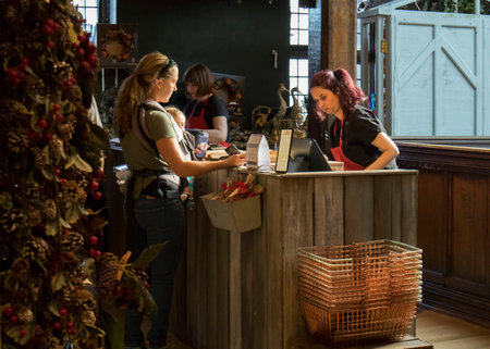 London, UK - 20 September 2020, A salesperson in the Christmas toys department at a Liberty store wraps the goodsのeditorial素材