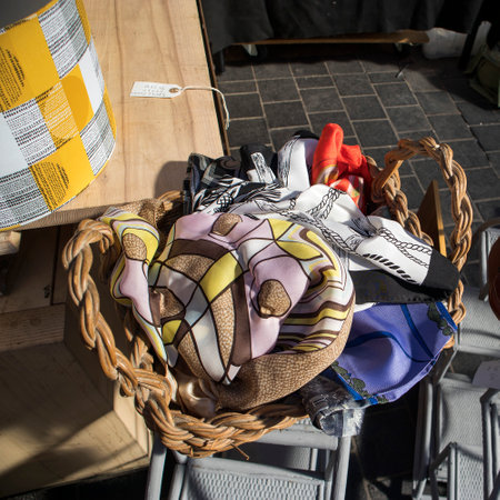 London, UK - 20 September 2020, Vintage shawls in a wicker basket for sale at Spitalfields flea...