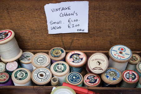 Liverpool Street, London, UK, - 21 September 2020, Spitalfields Antique Market. Everything for sewing: spools of thread in a wooden box. The box says - vintage cottonのeditorial素材