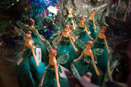 LONDON, UK - December 22, 2020: Christmas decorations in Liberty shopping mall, one of the oldest department stores in London. Plastic fairies in green dresses with wings - Christmas tree decorationのeditorial素材