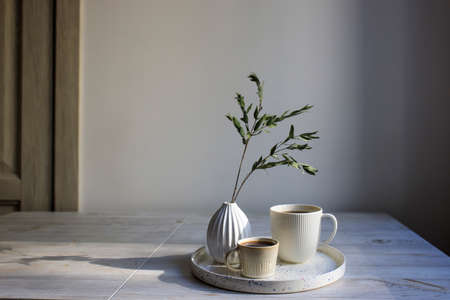 Minimalistic Scandinavian style. two cups of coffee of different sizes for two on a tray on the...