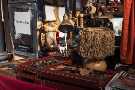 Liverpool Street, London, UK, - 21 September 2020, Spitalfields Antique Market. Porcelain figurines, vases, earthenware cup, plates, photo frames, bone beads, dog figures for sale at the flea market.のeditorial素材