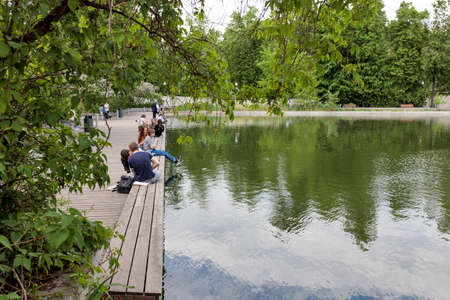 Moscow, Russia - May, 2021, Gorky Central Park of Culture and Leisure. People are resting on the pier near the artificial pondのeditorial素材