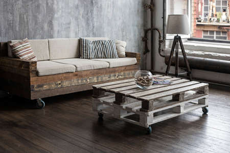 Moscow, Russia - 12 June 2021, Wooden block sofa and coffee table. Waste-free production. Round vase...