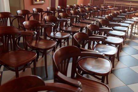 Row of wooden chairs in a concert hallの写真素材