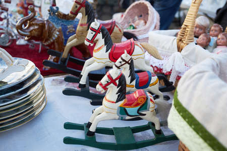 Moscow, Russia - 04 September 2021, Wooden rocking horse white in red patterns in a row at the flea market at the weekend in the Museum of Moscowのeditorial素材
