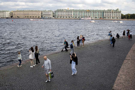 Saint Petersburg, Russia - 14 September 2021, view from vasilievsky island to the palace embankment with the hermitage. People walk along the embankment near the Neva Riverのeditorial素材