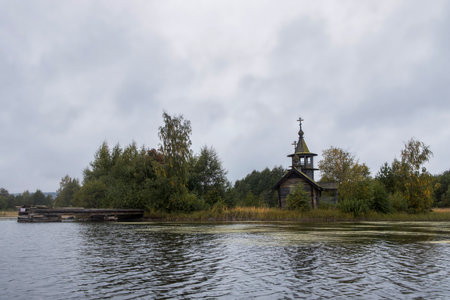 Kizhi, Karelia, Russia - September 2021, The chapel of Paraskeva Pyatnitsa and Varlaam Khutynsky is located at some distance from the coastline of Lake Onega on high hill, among of fir trees.のeditorial素材
