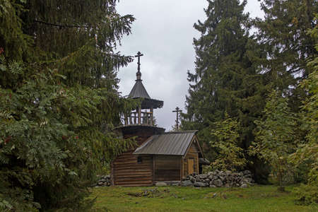 Kizhi, Karelia, Russia - September 2021, The chapel of Paraskeva Pyatnitsa and Varlaam Khutynsky is located at some distance from the coastline of Lake Onega on high hill, among of fir trees.のeditorial素材