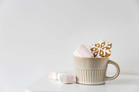 Christmas or New Year composition with cocoa, gingerbread cookies and christmas decorations. Hot chocolate with marshmallows on a white background of table. Copy space. Mock upの写真素材