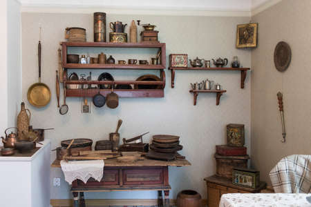 Kitchen. Wooden shelves lined with antique kitchen utensils.の写真素材