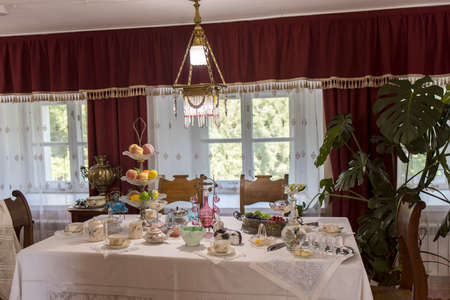 BOGORODITSK, TULA OBLAST, RUSSIA - JUNE 25 2021. The count Bobrinsky palace in Bogoroditsk city. Interior with table and utensils on itのeditorial素材