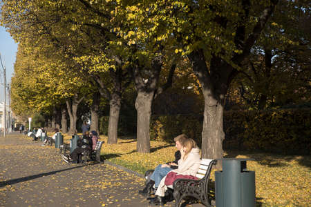 Moscow, Russia - 08 October 2021, Gorky Central Park of Culture and Leisure. man and woman sitting on a benchのeditorial素材