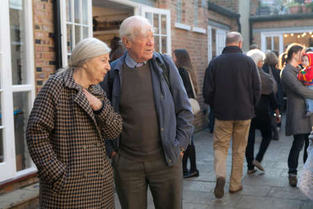 London, UK - 20 November 2019, A man and a woman are looking in the same direction while standing in...