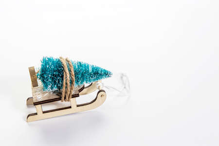 Wooden sleigh with decorative fir tree on white background. Christmas holidays. Copy space. Place for text. Cardの写真素材