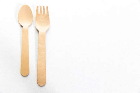 wooden spoon and folks isolated on the white background ready to cook and taste with the ingredients of your choice. Place for text. Copy spaceの写真素材