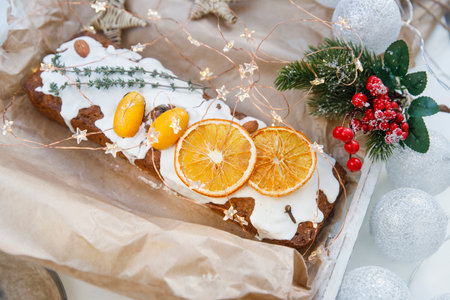 Traditional christmas cupcake garnished with dry orange wedges, clove spice and rosemary sprig in...