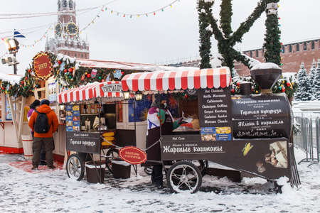 Moscow, Russia - 20 December 2021, GUM-fair on Red Square, Christmas market. Street trade. A steam locomotive stall selling roasted chestnuts and cornのeditorial素材