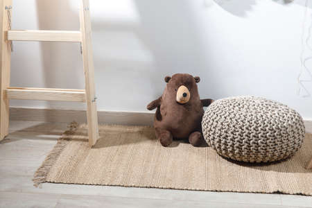 Fragment of the interior of the children's room, decorated for Easter. A ladder with a bear, a garland of fake colored eggs. Easter cardの写真素材