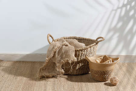 Storage room. Wooden stairs, wicker baskets on a mat.の写真素材